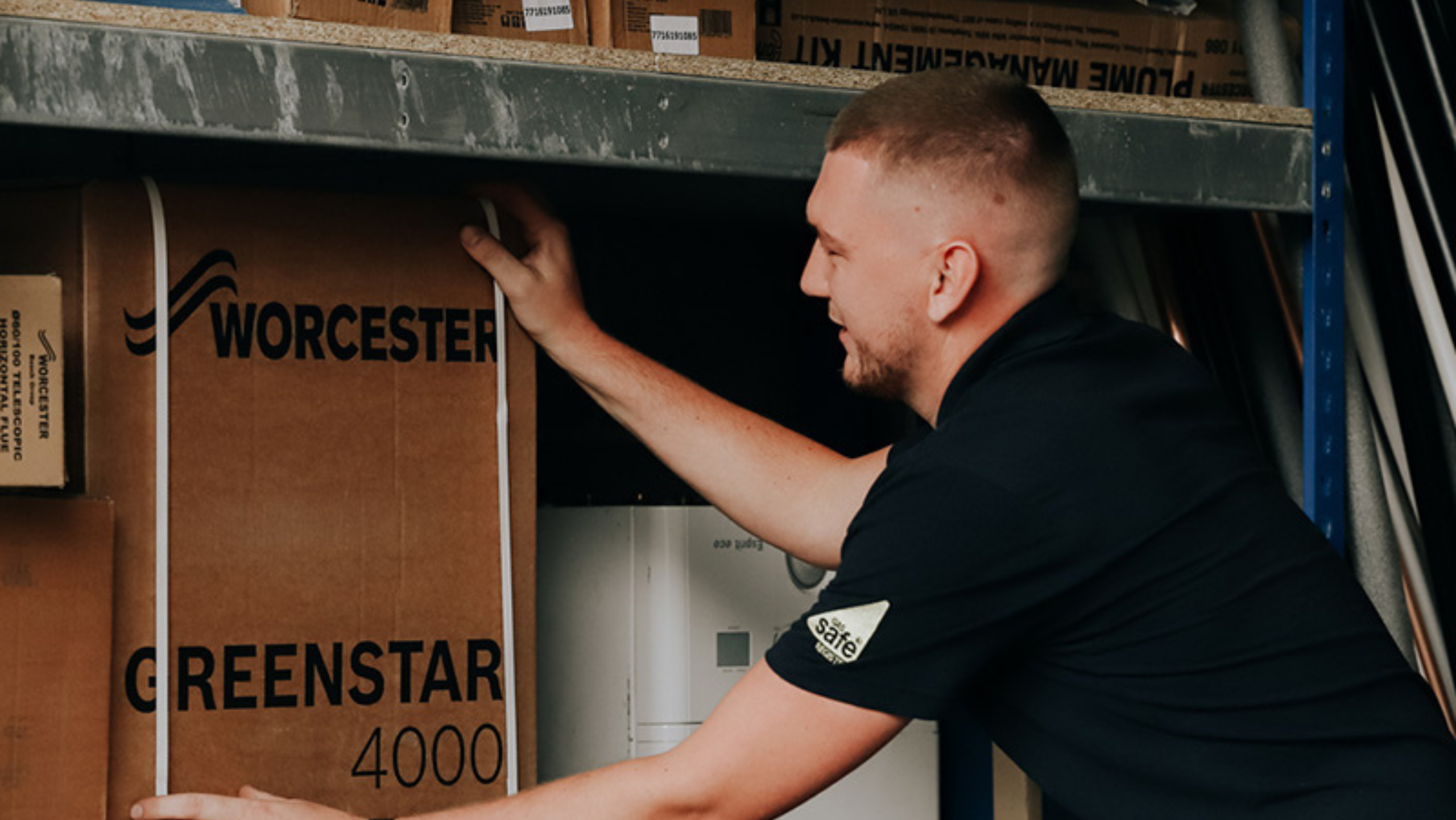 Heating engineer unloads new Worcester Bosch boiler from a van